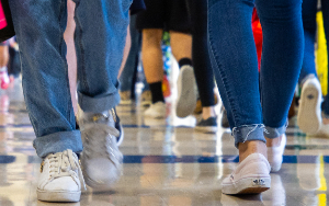  image of feet walking in hallway